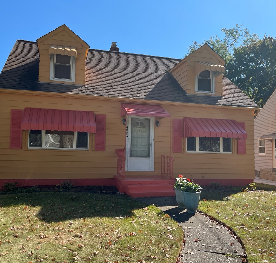 After Cape Cod exterior house painting in Akron Ohio — Akron painter completed yellow Cape Cod with red shutters and awnings, Akron painters residential exterior painting results Akron Ohio