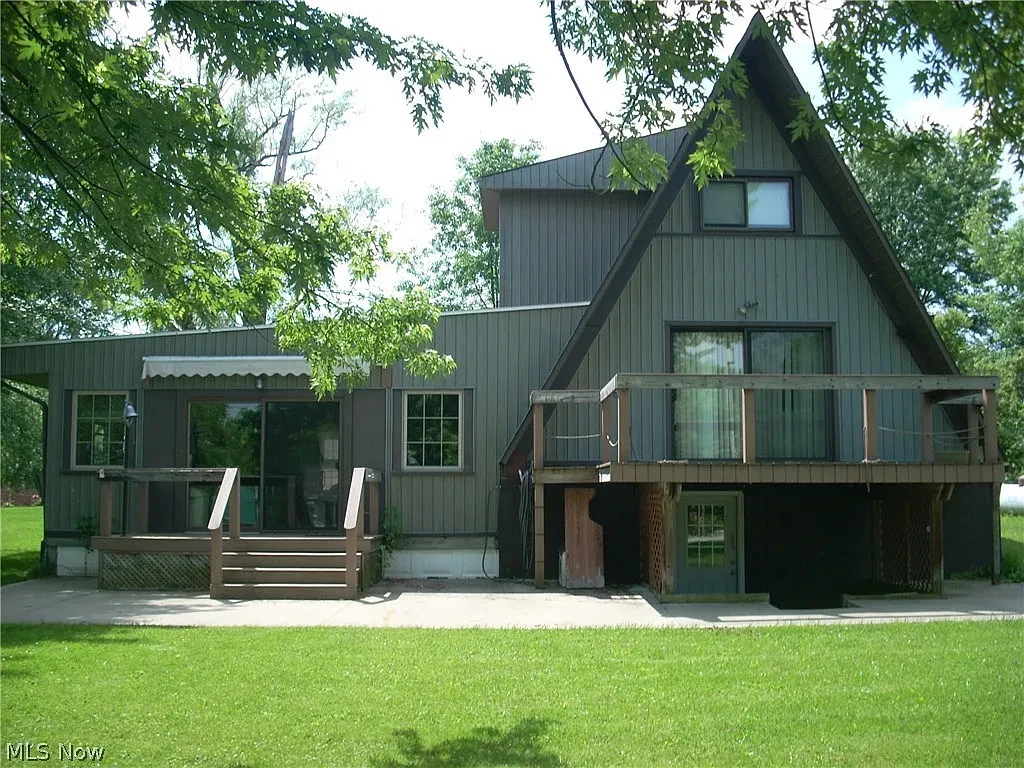 Before A-frame exterior house painting in Akron Ohio — Akron painter prepping dark green A-frame siding, Akron painters exterior painting project before