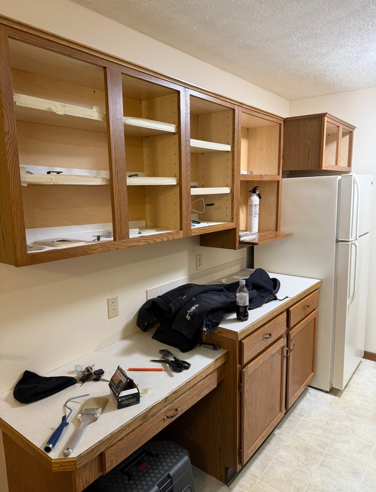 Before kitchen cabinet painting in Akron Ohio — Akron painter prepping oak cabinets, Akron painters cabinet refinishing project