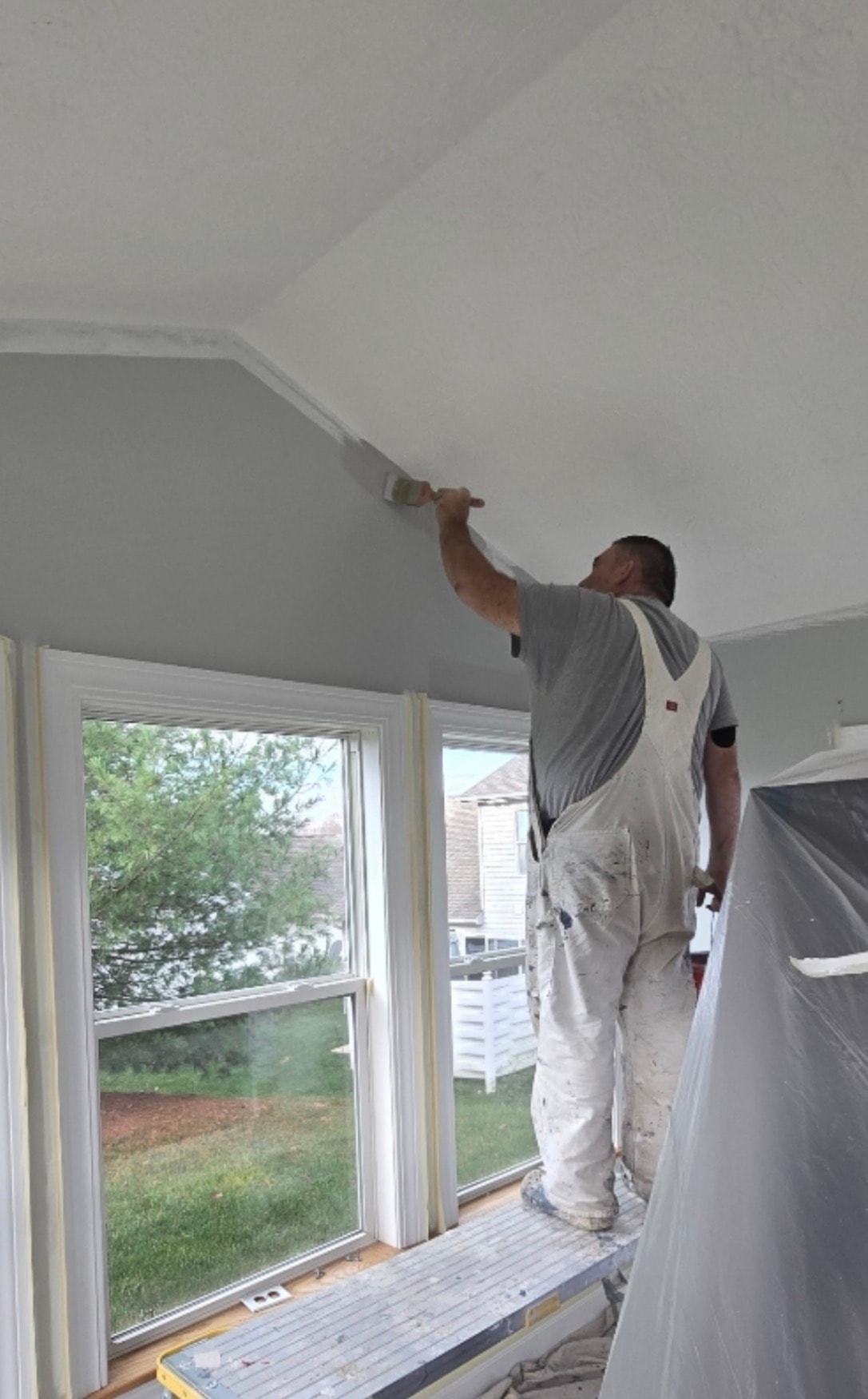 Jay the Akron painter on ladder painting ceiling trim — Kenmore Painters interior painting Akron Ohio