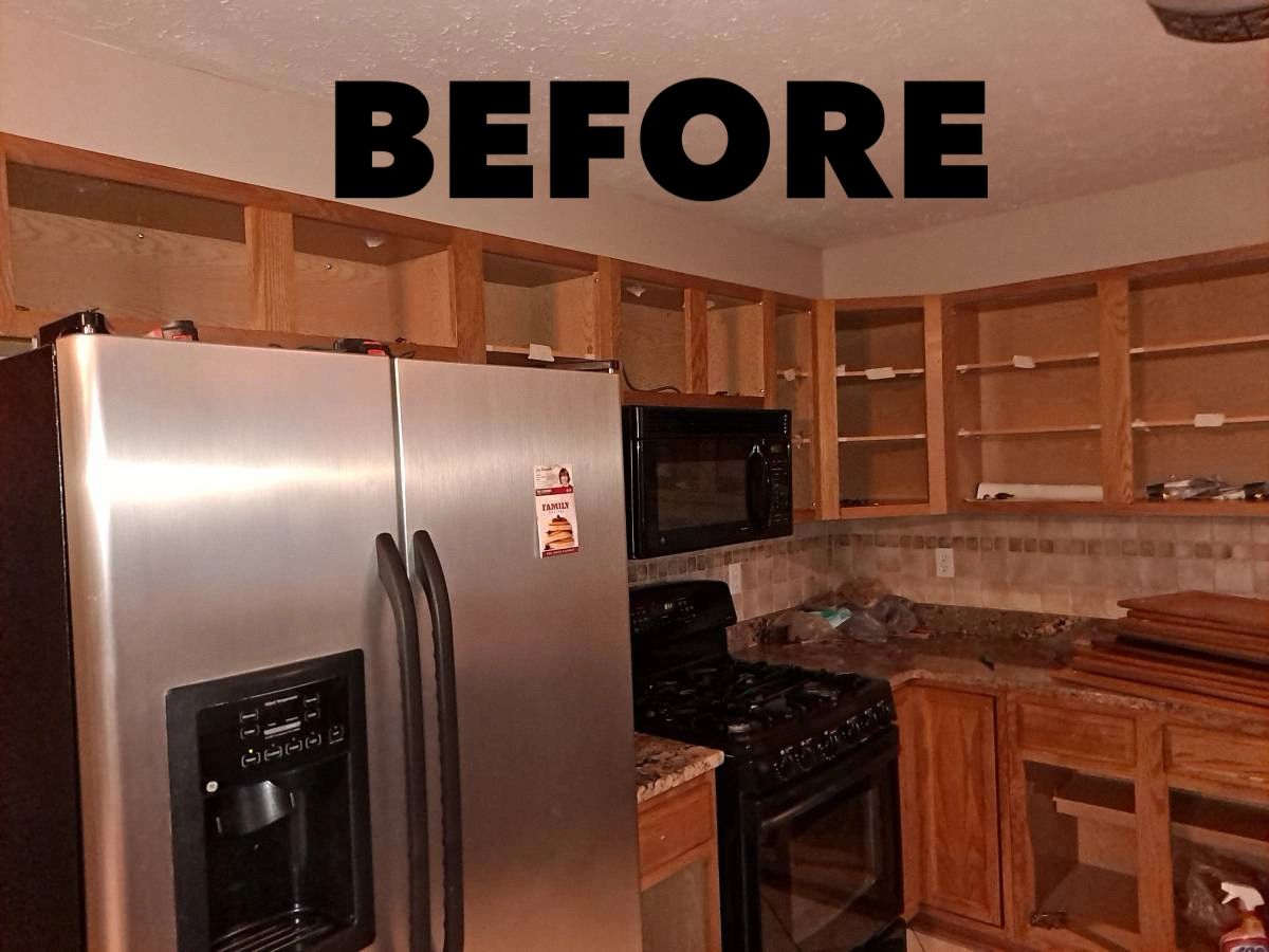 Kitchen before — dated wood cabinets