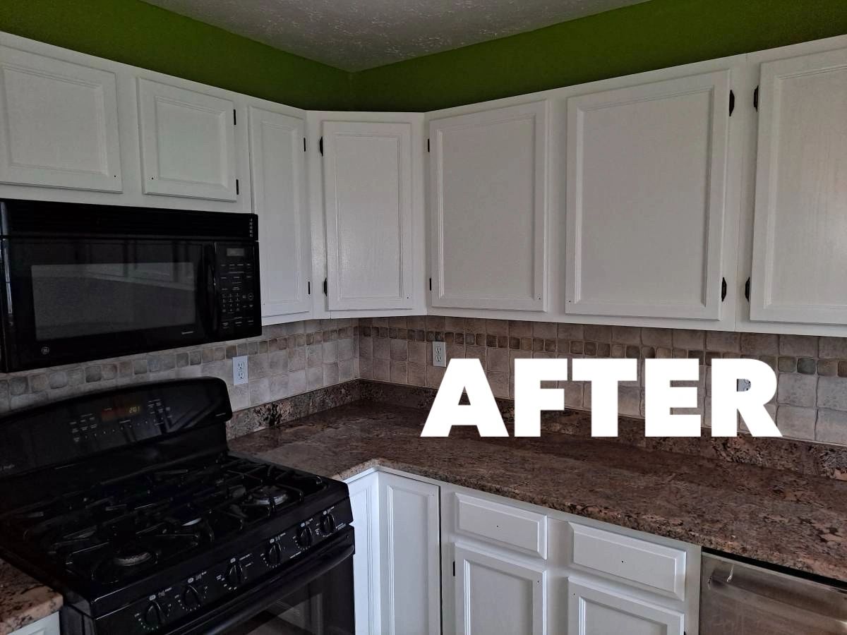 Kitchen after — white cabinets, green walls